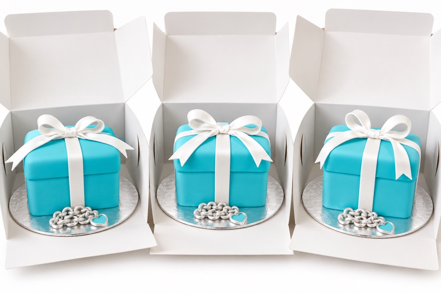 Three aqua gift box cakes with white bows